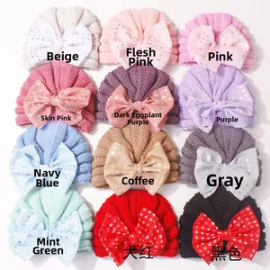 Grid view of 12 colors of baby knit turbans with large silver star print bows