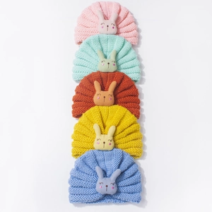 Close-up of baby knit turban hats with 3D bunny decor in various vibrant colors