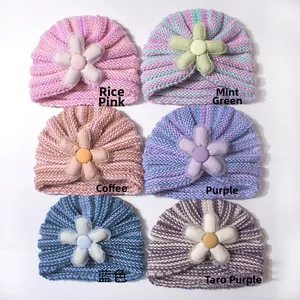 Close-up of baby knit hats with pleated twist texture and 3D floral accents in 6 colors