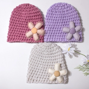 Three-piece infant knit hat set in pink, lilac, and cream with plush floral decorations