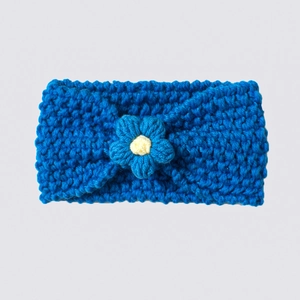 Detailed texture of blue hand-knitted baby headband with a soft crochet flower accent