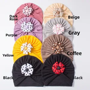 Detail view of 8 colors of baby waffle knit turban hats with 3D polka dot floral accents