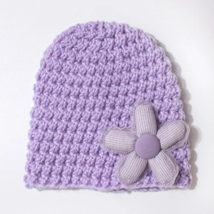 Close-up of thick knitted purple baby hat with large handmade 3D corduroy flower detail