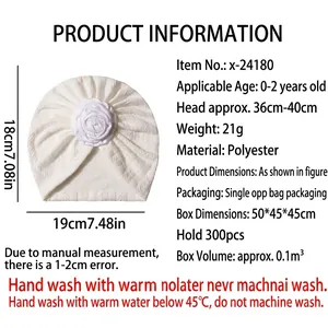 Cute white baby turban hat with large 3D flower decoration and textured knit fabric