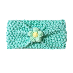 Soft mint green knitted baby headband with a handmade flower and comfortable nylon band