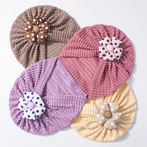 Set of four infant turban hats in waffle knit fabric with polka dot floral accents