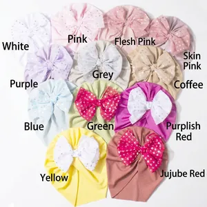 Detailed view of ribbed baby turban hats with silver star print bow in various colors