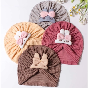 Detail of waffle knit fabric textures and rabbit motifs in four soft pastel colors