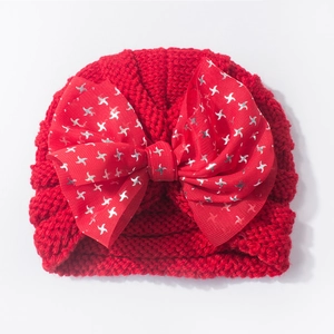 Red knit baby hat with a large glitter star sequin mesh bow for festive warmth