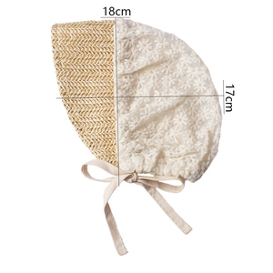 Detail view of baby sun hat with lace flowers and size dimensions 18cm by 17cm