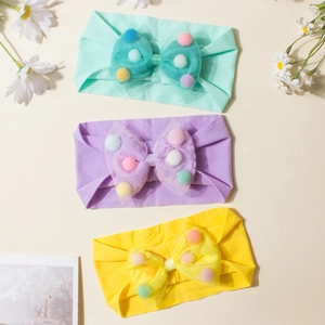 Soft baby headband set with colorful mesh bows and pom-poms in green, purple, and yellow