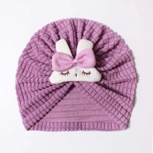 Detail of purple infant hat with textured knit fabric and a cute white bunny patch