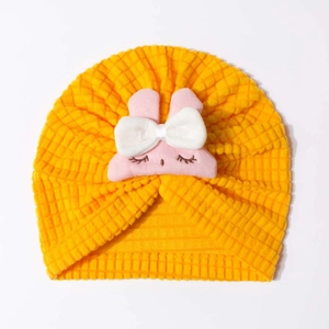 Bright yellow waffle baby turban hat featuring a cute pink rabbit patch and ear protection