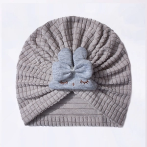 Detailed view of the dark grey waffle knit fabric and cute bunny ear design on baby hat