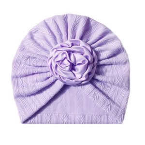 Detailed view of lavender baby turban featuring knit texture and 3D satin rose flower