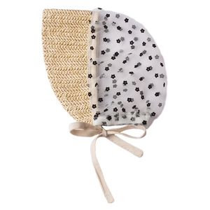 Detail of baby bonnet with beige straw weave, mesh floral fabric, and secure chin straps
