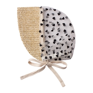 Detail of baby sun hat featuring woven straw material with black heart polka dot mesh ribbon