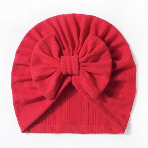 Cute red waffle knit baby hat featuring a large decorative bow for newborns and infants