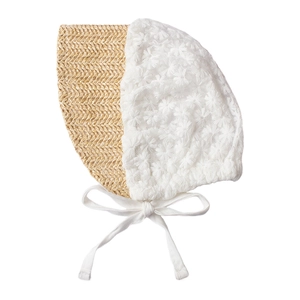 Detail of baby sun hat with woven straw brim and white daisy lace embroidery