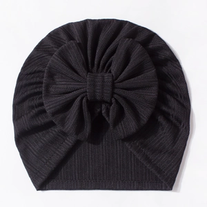 Detailed close-up of a black waffle texture baby turban hat with a large decorative bow
