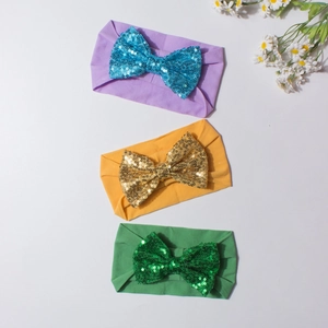 Trois bandeaux pour bébé aux couleurs vives avec de grands nœuds en paillettes et nylon