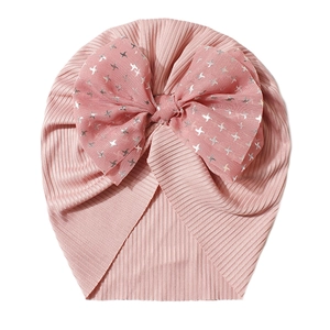Macro shot of pink ribbed knit baby turban featuring a sheer silver bird print bow