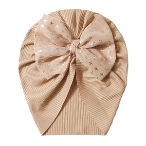 Detail of baby turban hat showing ribbed knit fabric and silver star tulle bow
