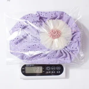 Detailed view of lightweight purple lace baby bonnet weighing 23g on a digital scale