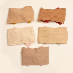 Detail of 5-piece infant knit headbands with cable texture and silk ribbon bows