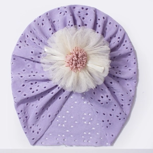 Detail of baby headband with eyelet knit fabric and large 3D mesh floral decoration