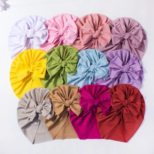 Set of 12 ribbed baby turban hats with large bows in various vibrant colors