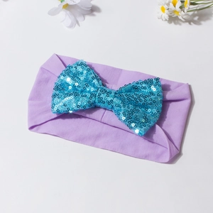 Bandeau élastique bébé en tissu violet clair avec un grand nœud en paillettes turquoise