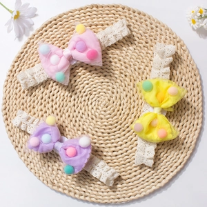 Three-piece baby lace headband set with colorful pom-pom mesh bows on a straw mat