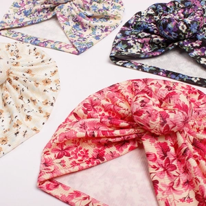 Soft ribbed baby donut headbands with four varied floral prints and twisted knot design