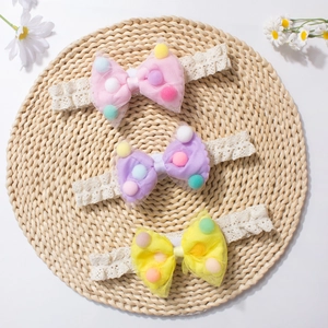 Three-piece baby lace headbands with colorful mesh bows on a rustic woven mat