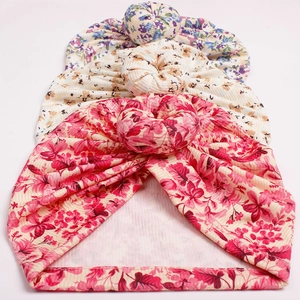 Three-pack floral baby donut turbans in soft ribbed knit fabric for infants