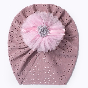 Detail of baby turban hat featuring a pink layered lace flower and heart-shaped mesh texture
