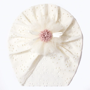 Detailed view of baby turban with eyelet lace, mesh flower, and white ribbon bows