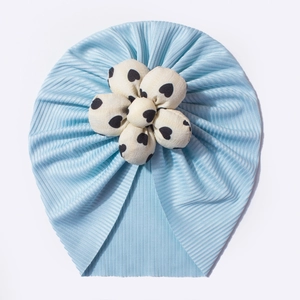 Close-up of baby turban fabric with light blue rib texture and white heart flower