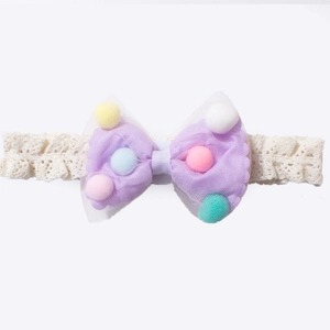 Elastic baby lace headband with purple bow and colorful pom-poms on white background