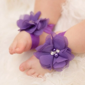 Detailed close-up of purple chiffon flower barefoot sandals with rhinestones for infants