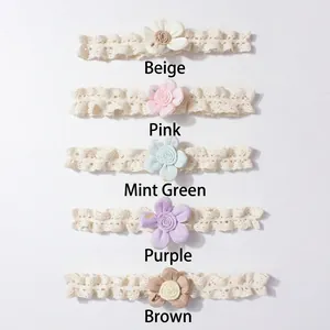 Detail view of five colors of lace baby headbands including pink, mint and beige floral styles