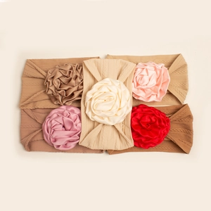 Detailed set of 5 knitted baby headbands with large satin roses in various elegant colors