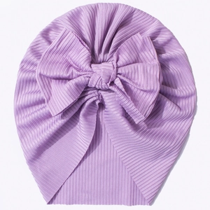 Close-up of lavender ribbed knit baby turban featuring a large decorative bow