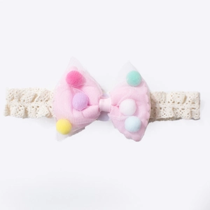 Cute baby lace headband with pink mesh bow filled with colorful plush pom-poms