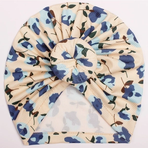 Detail of baby donut turban hat with blue floral print and ribbed knit fabric texture