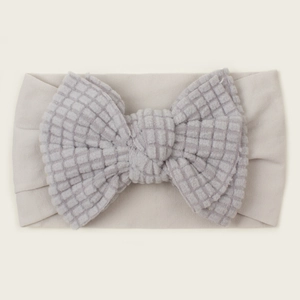 Neutral grey ribbed baby headband with a large waffle fabric bow for infants and toddlers