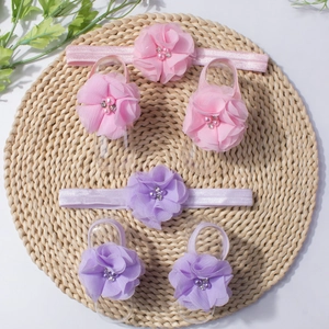 Detail view of pink and purple chiffon flower headbands and barefoot sandals for babies
