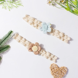 Detailed macro view of two baby lace headbands with blue and brown floral fabric accents