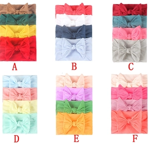 Detail view of 4-piece soft nylon baby headband sets in assorted color combinations